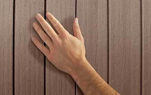 Hand touching a wooden surface